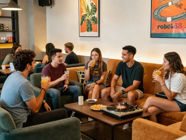 Friends enjoying drinks in a stylish lounge setting representing the lifestyle around rokok88